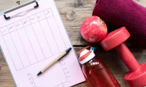 Plan treningowy: jak przygotować kondycję do wyprawy w góry wysokie bez siłowni. Jabłko, hantle, bidon i notatnik.
