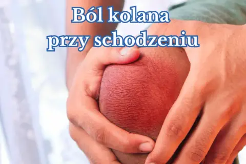 Dłonie obejmujące zaczerwienione kolano, symbolizujące ból kolana przy schodzeniu ze stromych tras.